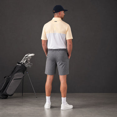 HARG Comfort Fit Golf Polo in lemon yellow and chalk white colorblock. Lightweight, breathable, moisture-wicking fabric.